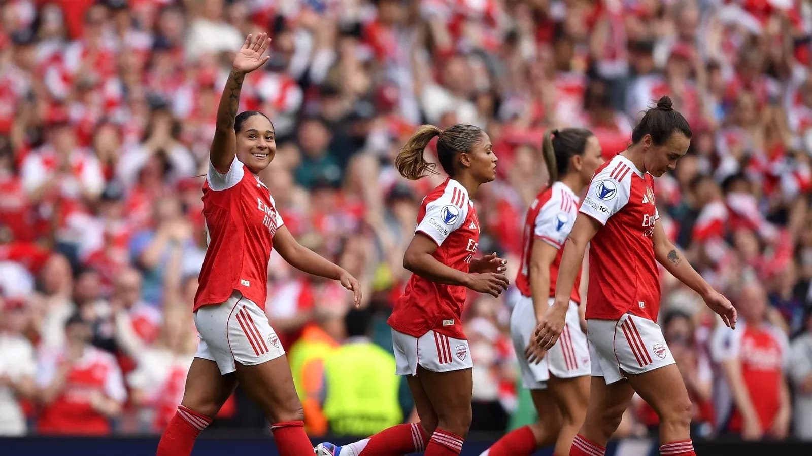 Jugadora de Arsenal saludando con equipo celebrando