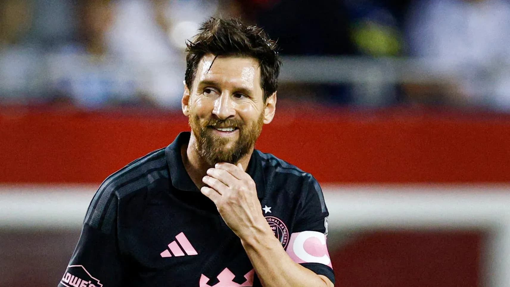 Jugador de fútbol con camiseta negra sonriendo