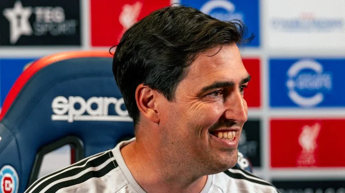 Entrenador sonriendo durante conferencia de prensa