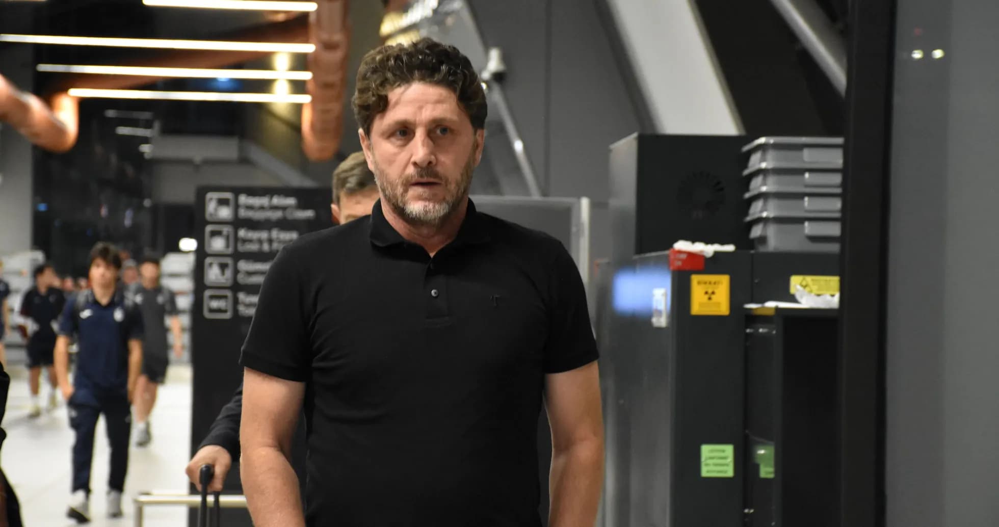 Entrenador caminando en pasillo del aeropuerto