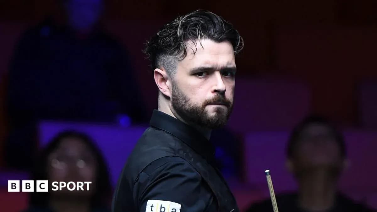 Jugador de snooker sosteniendo un taco en la mesa