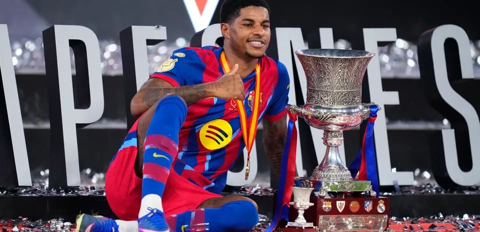 Jugador de Barcelona celebrando con trofeo en el podio
