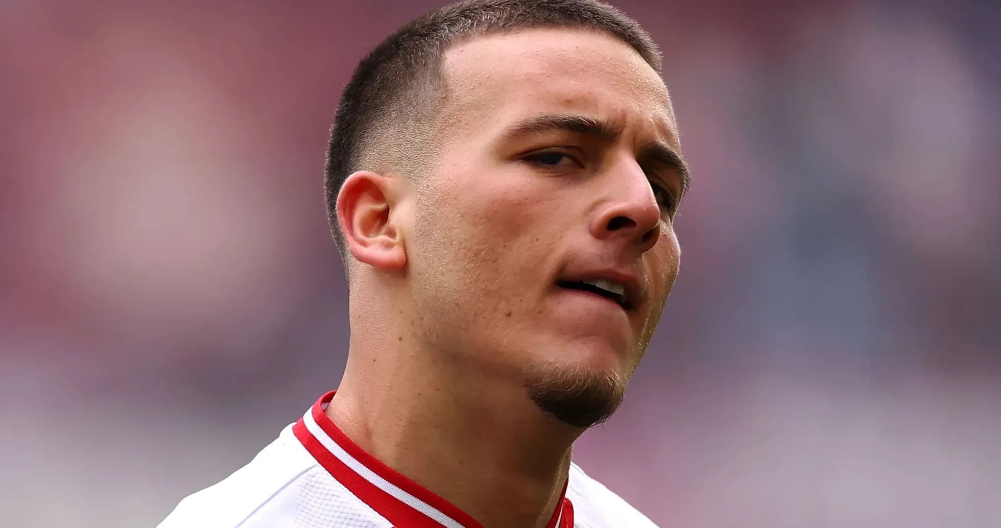 Jugador con camiseta blanca y roja en el campo