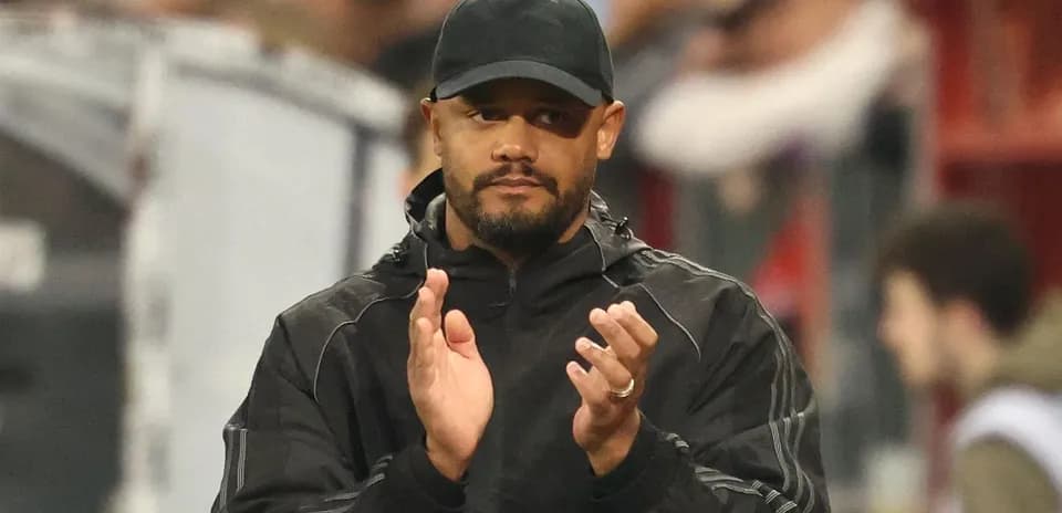 Entrenador aplaudiendo en la banda del estadio