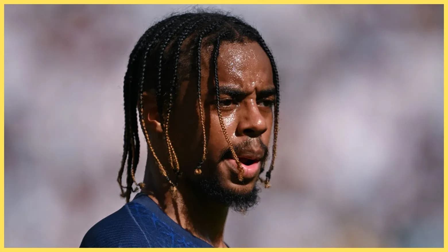 Jugador con trenzas en el campo de fútbol