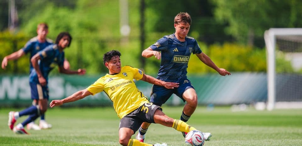 Jugador del Columbus Crew II derrapando en el campo
