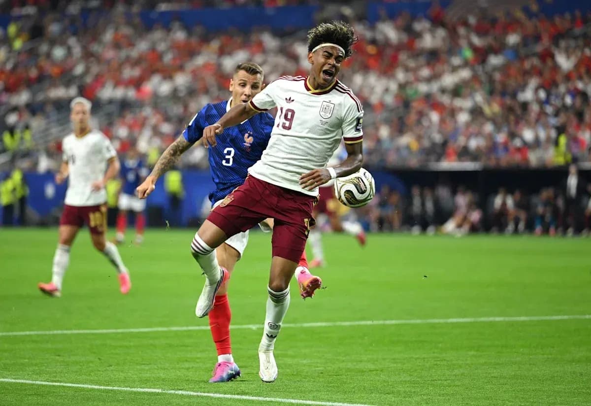 Jugador de España driblando mientras es perseguido por francés