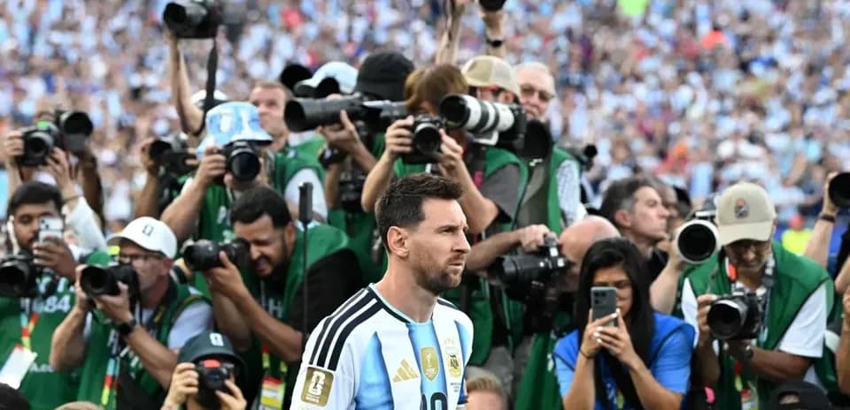 Lionel Messi surrounded by photographers during event