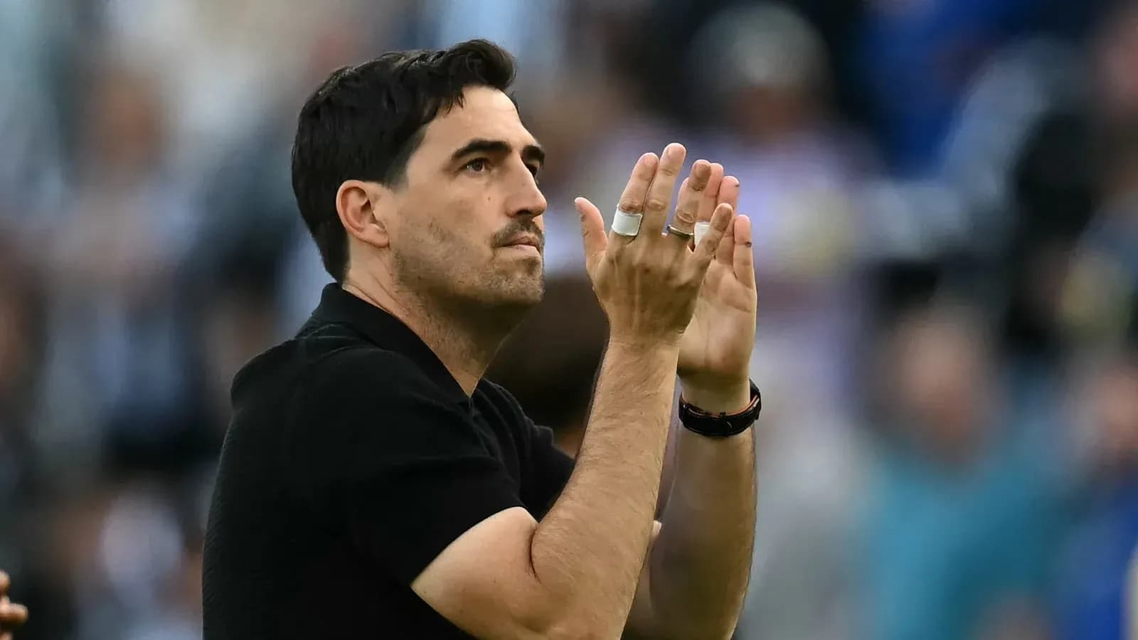 Entrenador aplaudiendo en el campo de juego