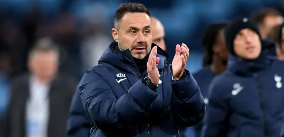 Entrenador aplaudiendo a los jugadores en el banquillo