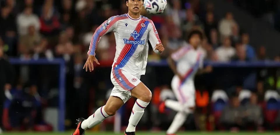 Jugador corriendo tras el balón en partido de fútbol