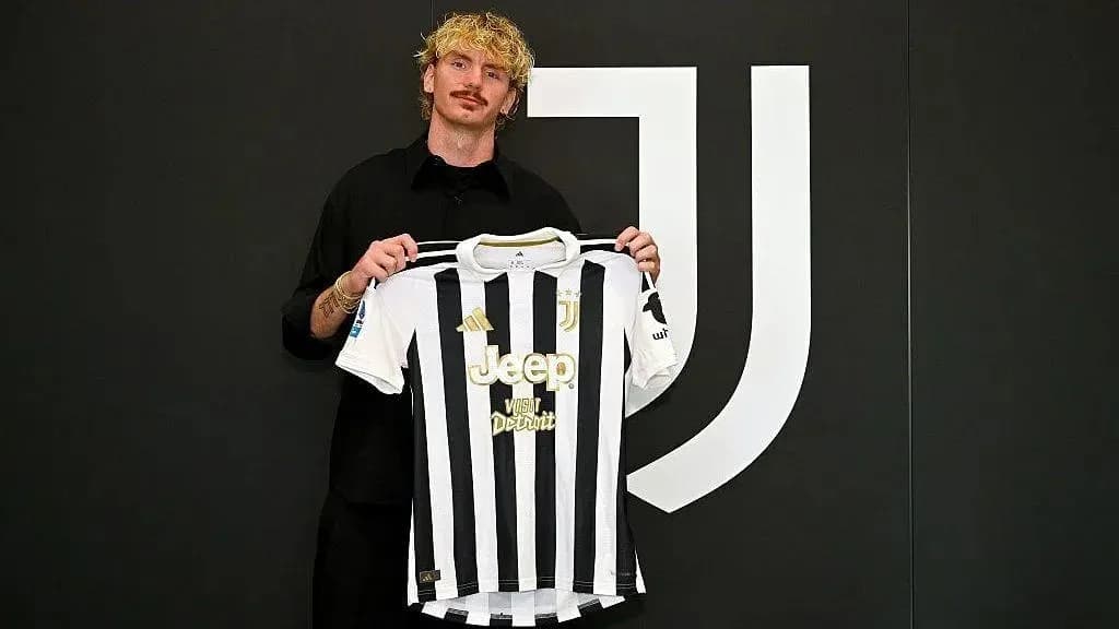 Jugador sosteniendo camiseta de Juventus en presentación