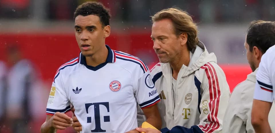 Jugador de Bayern Munich recibiendo instrucciones del entrenador