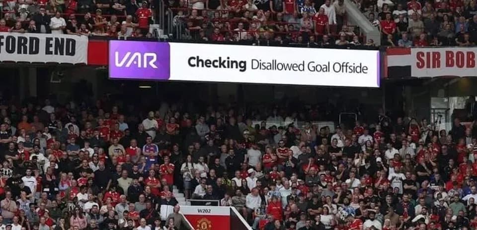 A crowd watching VAR check for disallowed goal