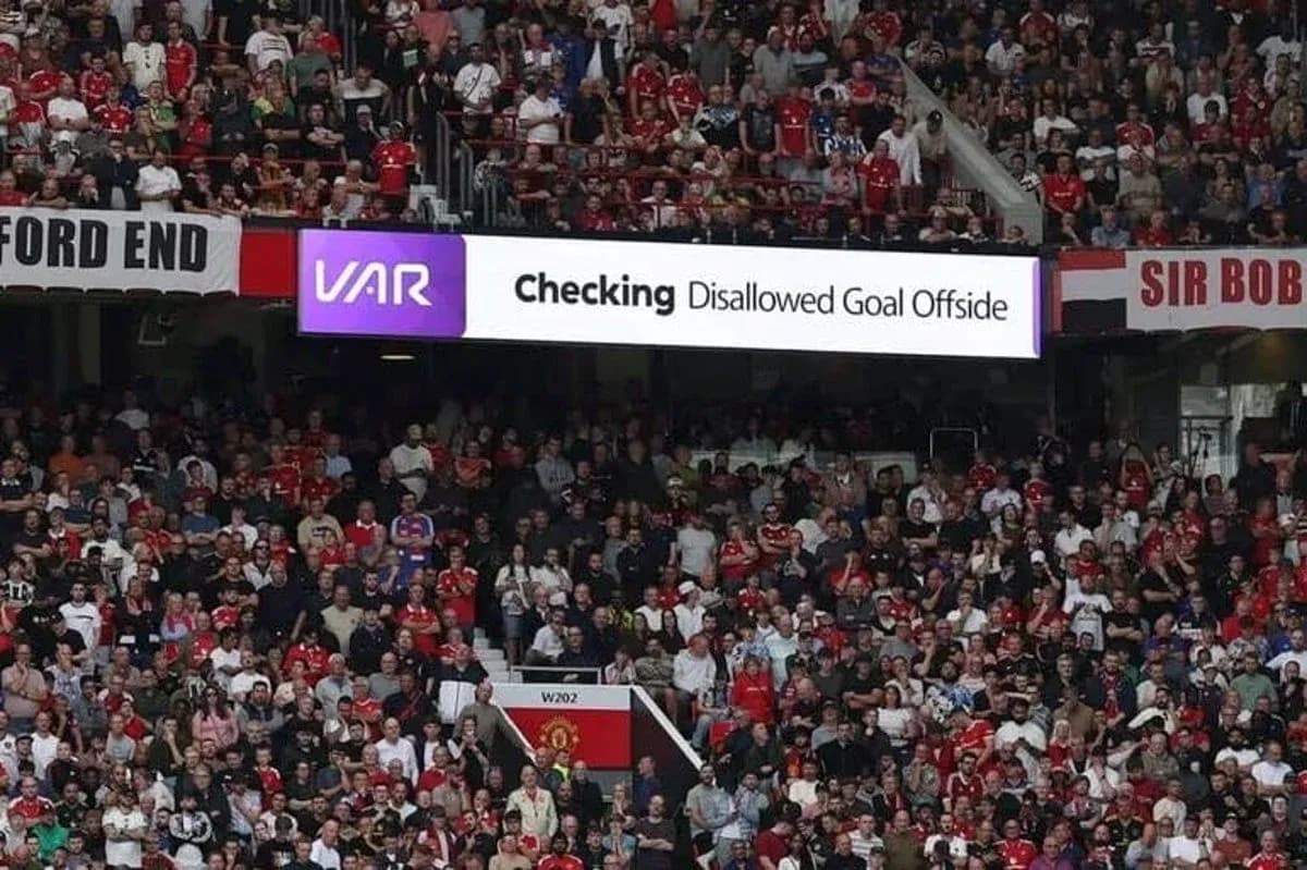 A crowd watching VAR check for disallowed goal