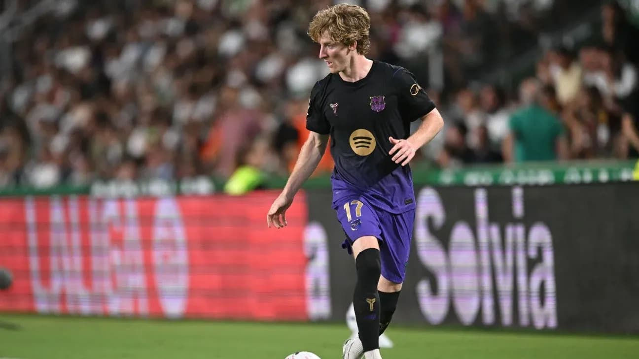 Jugador de fútbol corriendo con balón en el campo