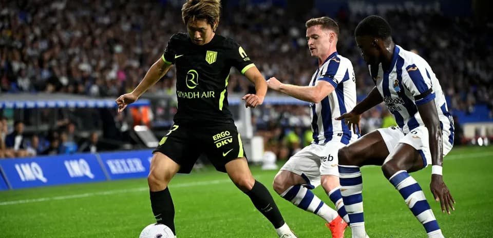 Jugadores de Real Sociedad y Atlético de Madrid compitiendo