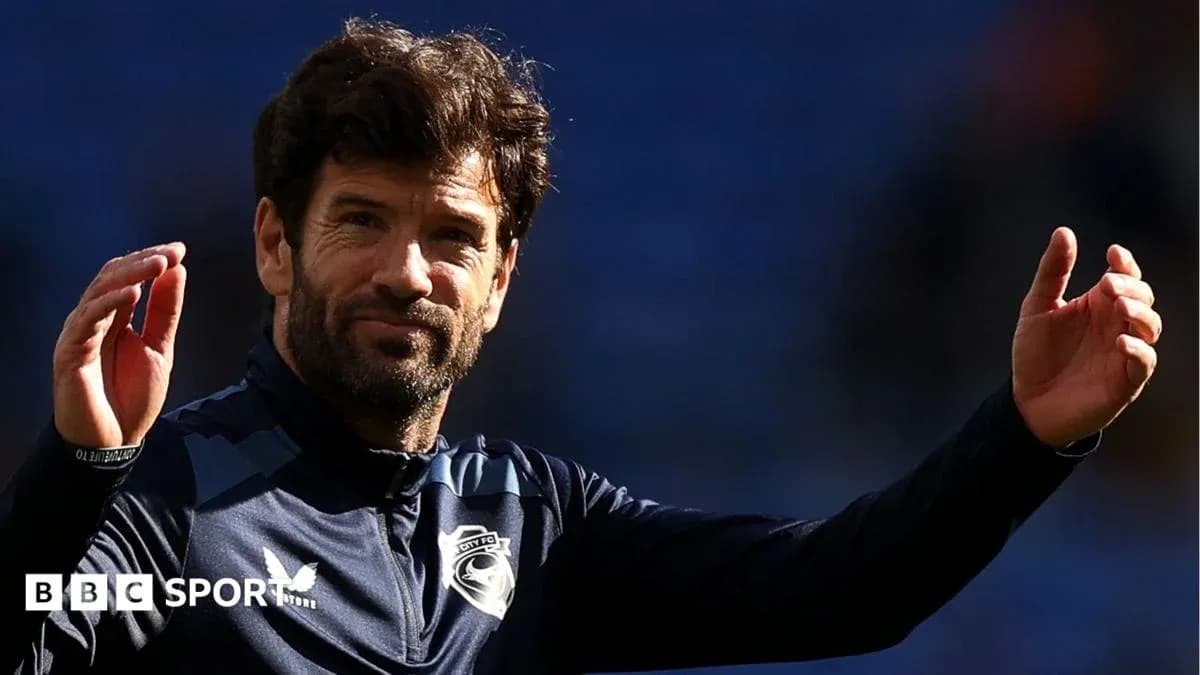 Entrenador saludando a la afición en el estadio