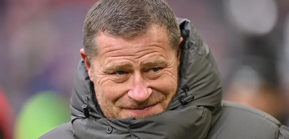 Entrenador con abrigo en el campo de fútbol