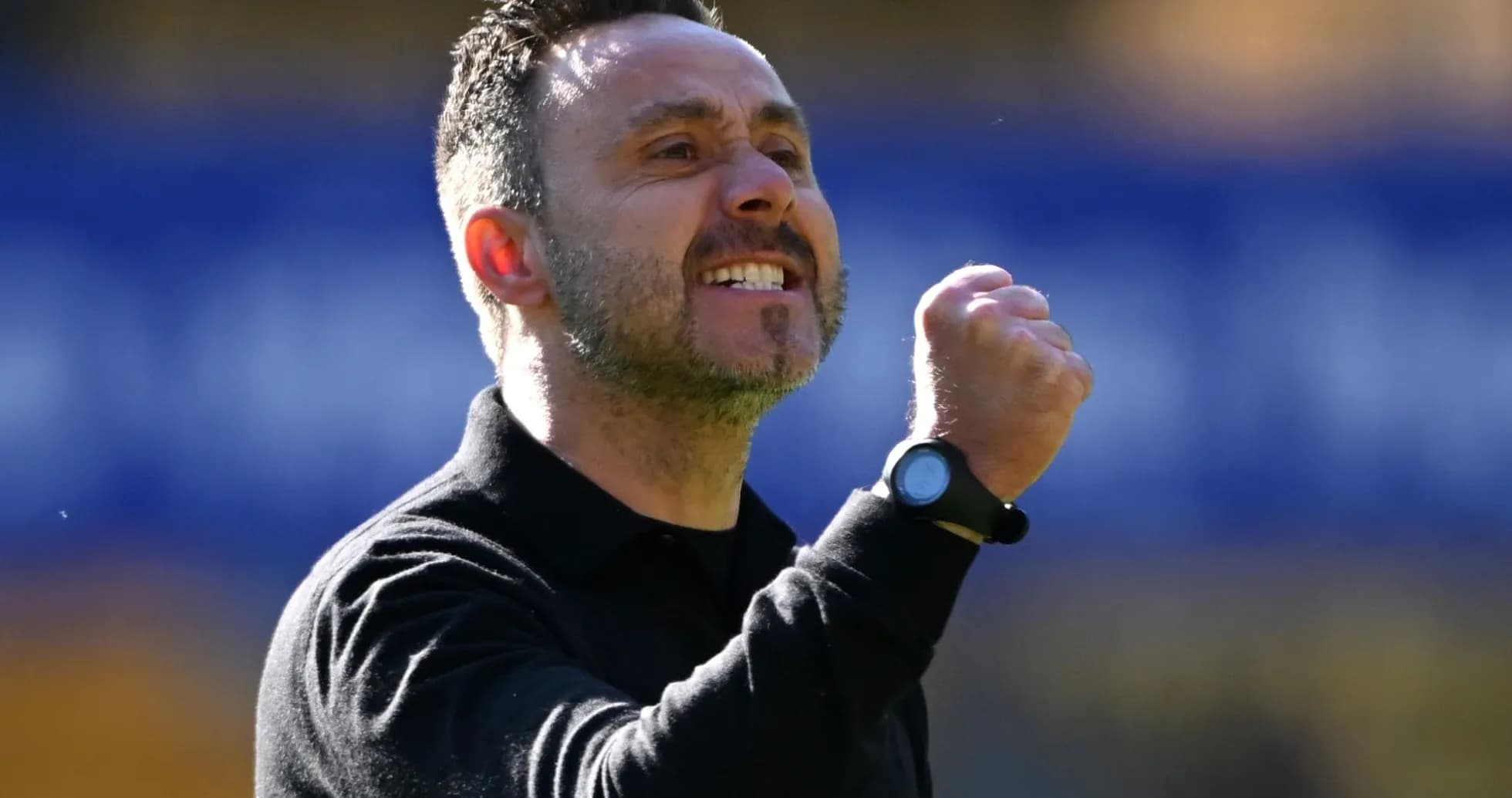 Entrenador celebrando con el puño cerrado enérgicamente