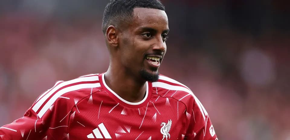Jugador de Liverpool sonriendo en camiseta roja