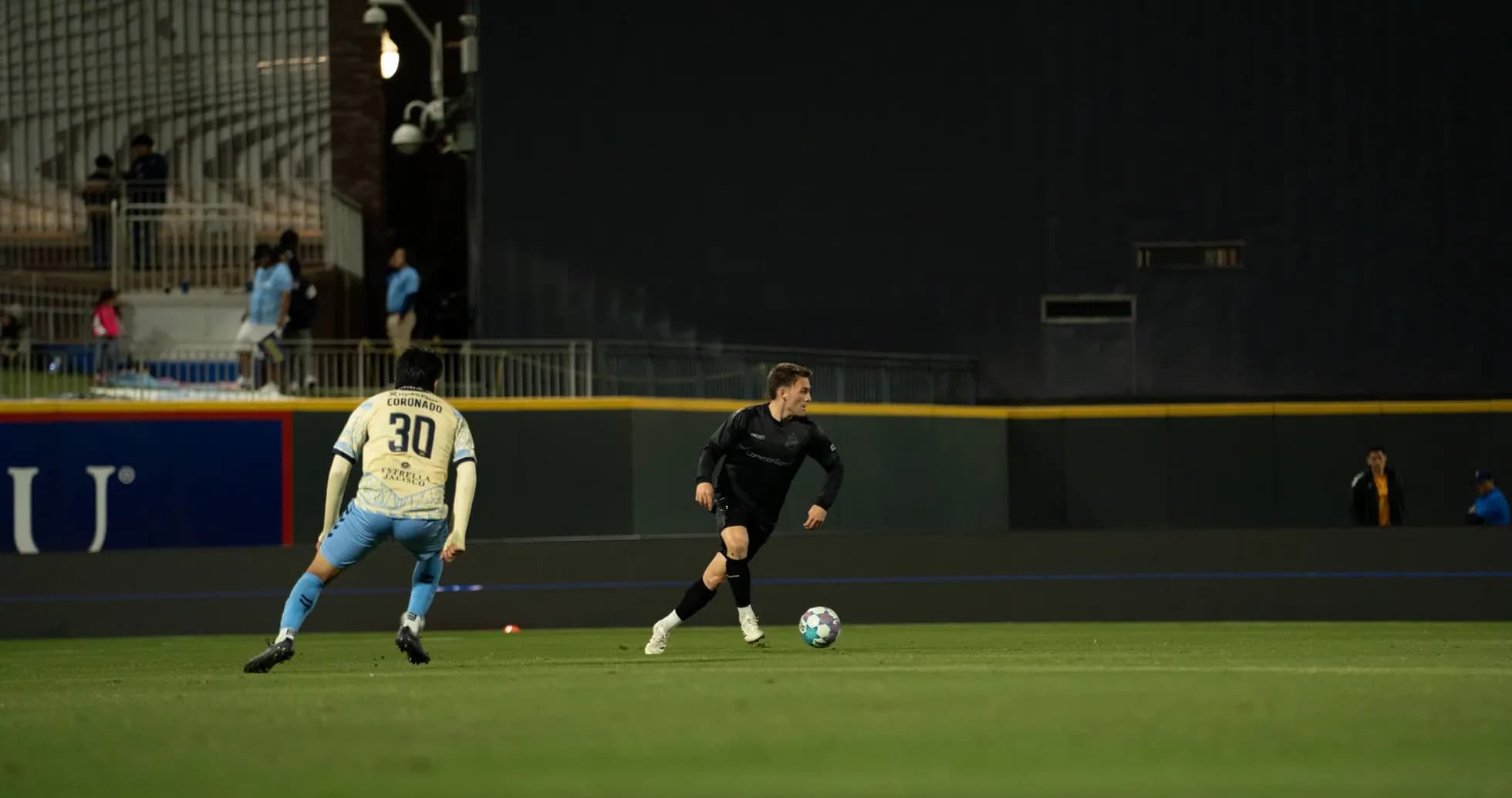 Jugador corriendo con balón en el partido