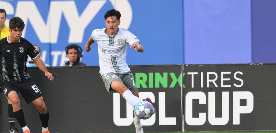 Jugador corriendo con el balón en el campo