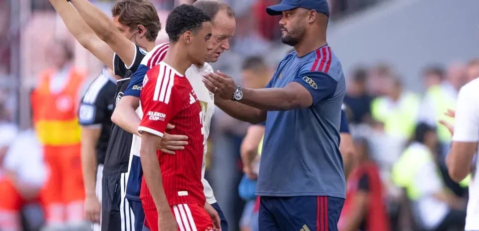 Entrenador hablando con jugador durante sustitución