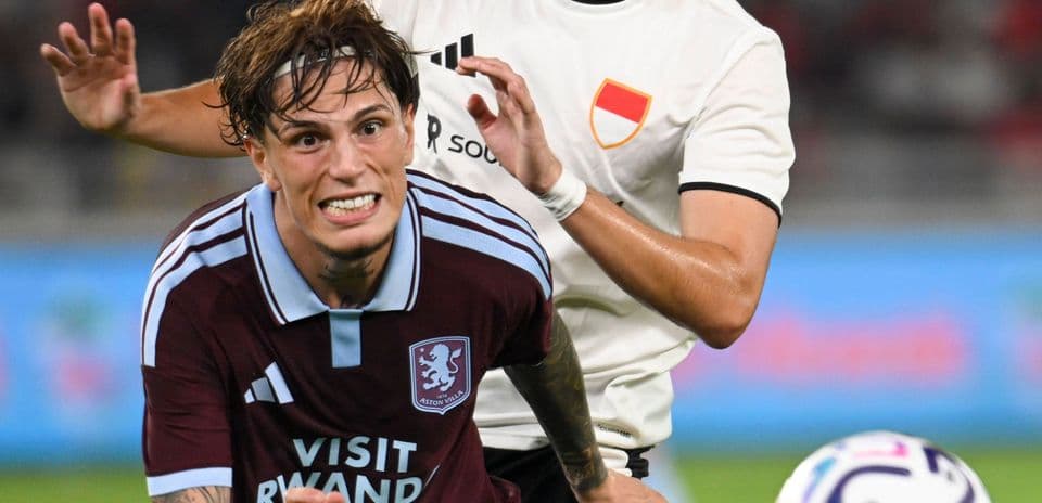 Jugador de Aston Villa siendo marcado por oponente