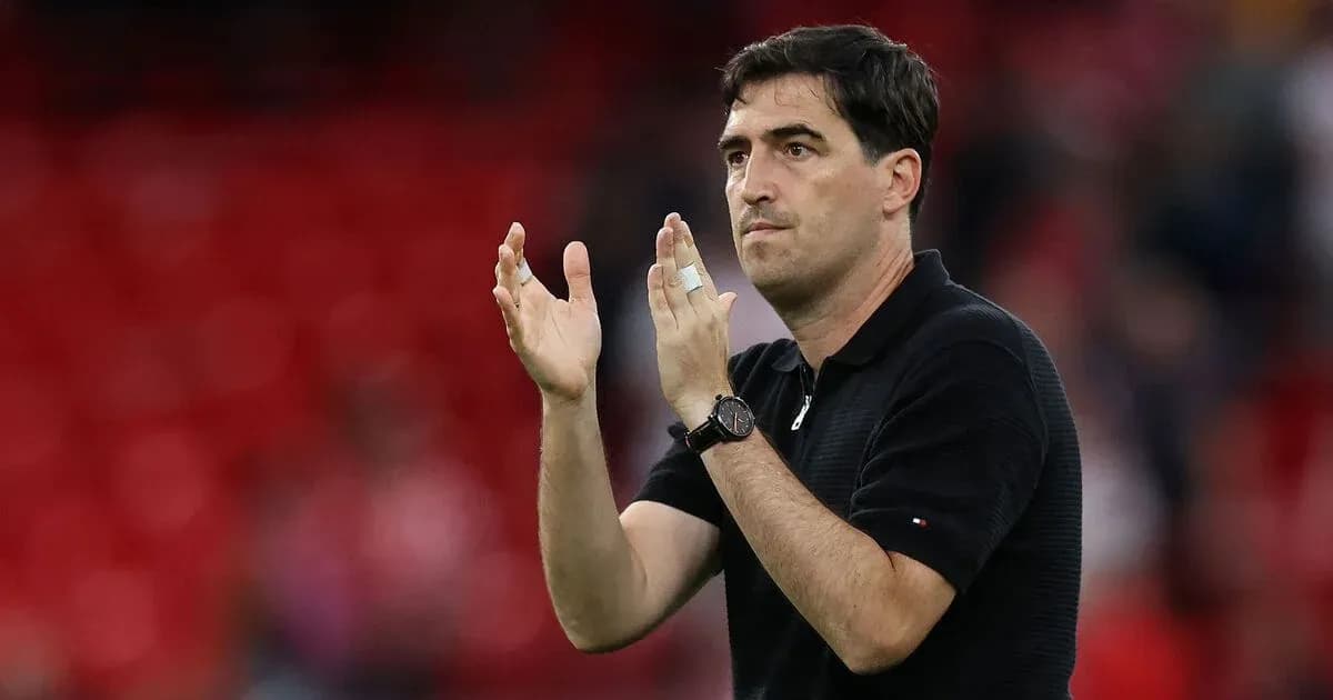 Entrenador aplaudiendo en el campo de fútbol