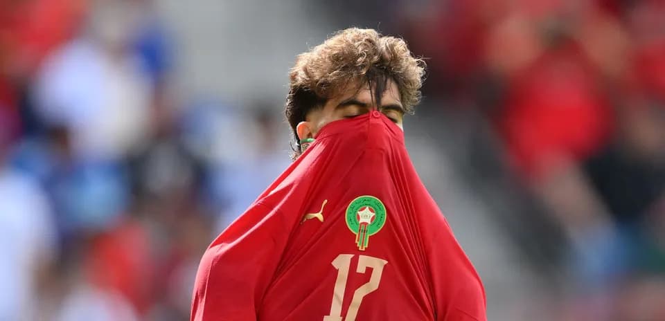 Jugador de Marruecos cubriendo su cara con la camiseta