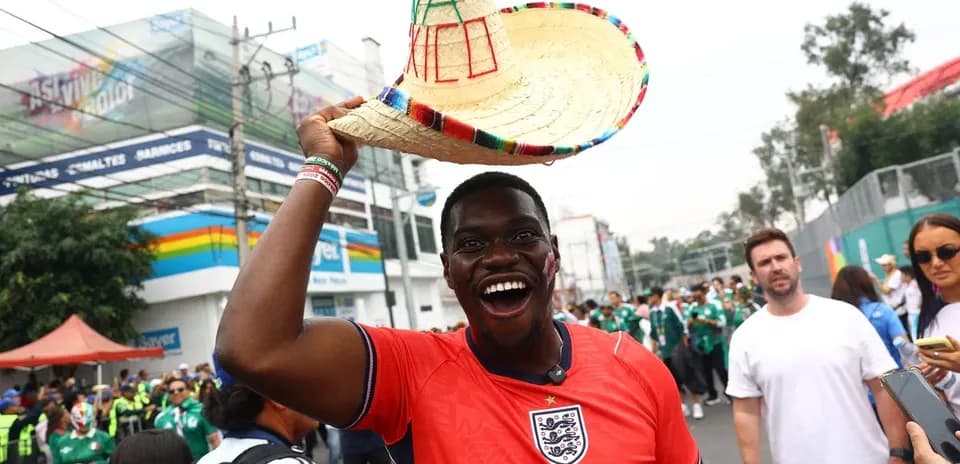 Fan wearing sombrero and England jersey celebrating