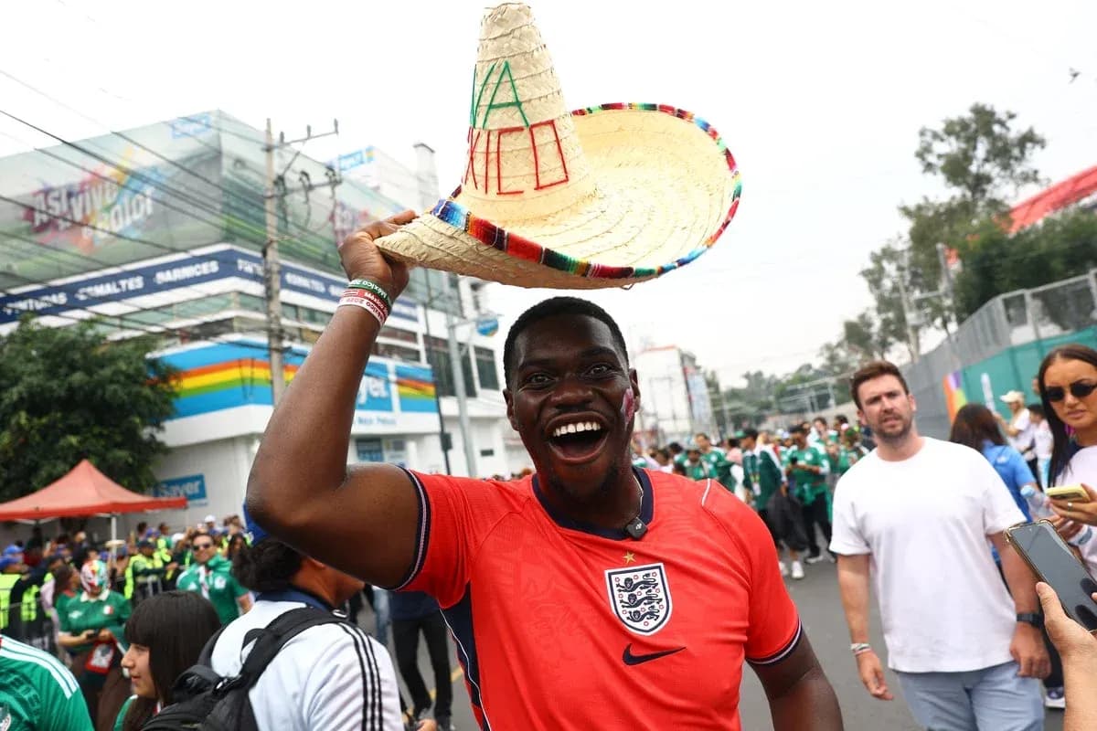 Fan wearing sombrero and England jersey celebrating