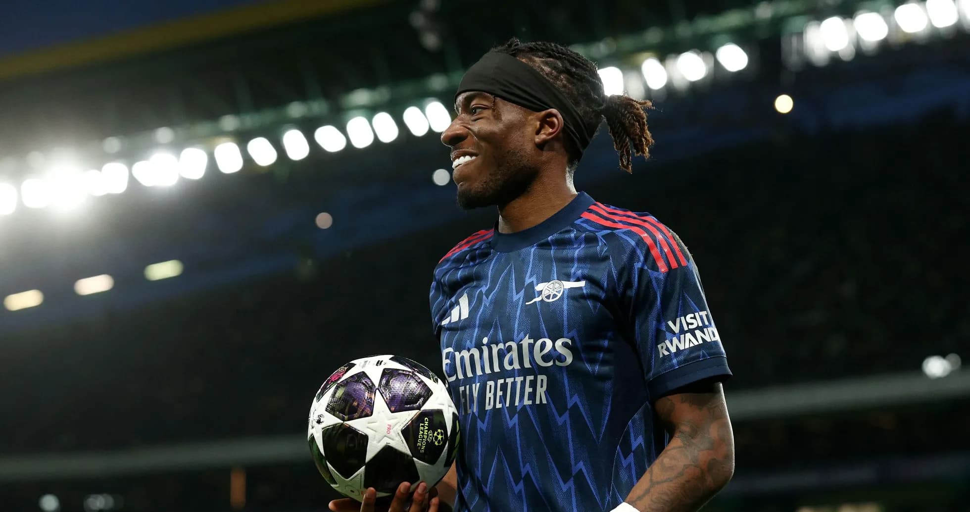 Jugador sosteniendo un balón de fútbol en el campo