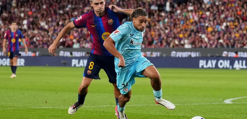 Jugador de Barcelona persiguiendo a oponente en el campo