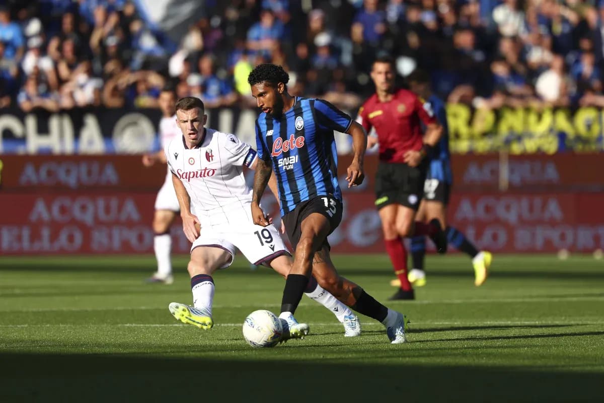 Jugador de Atalanta driblando a oponente de Bologna Jugador de Atalanta driblando a oponente de Bologna
