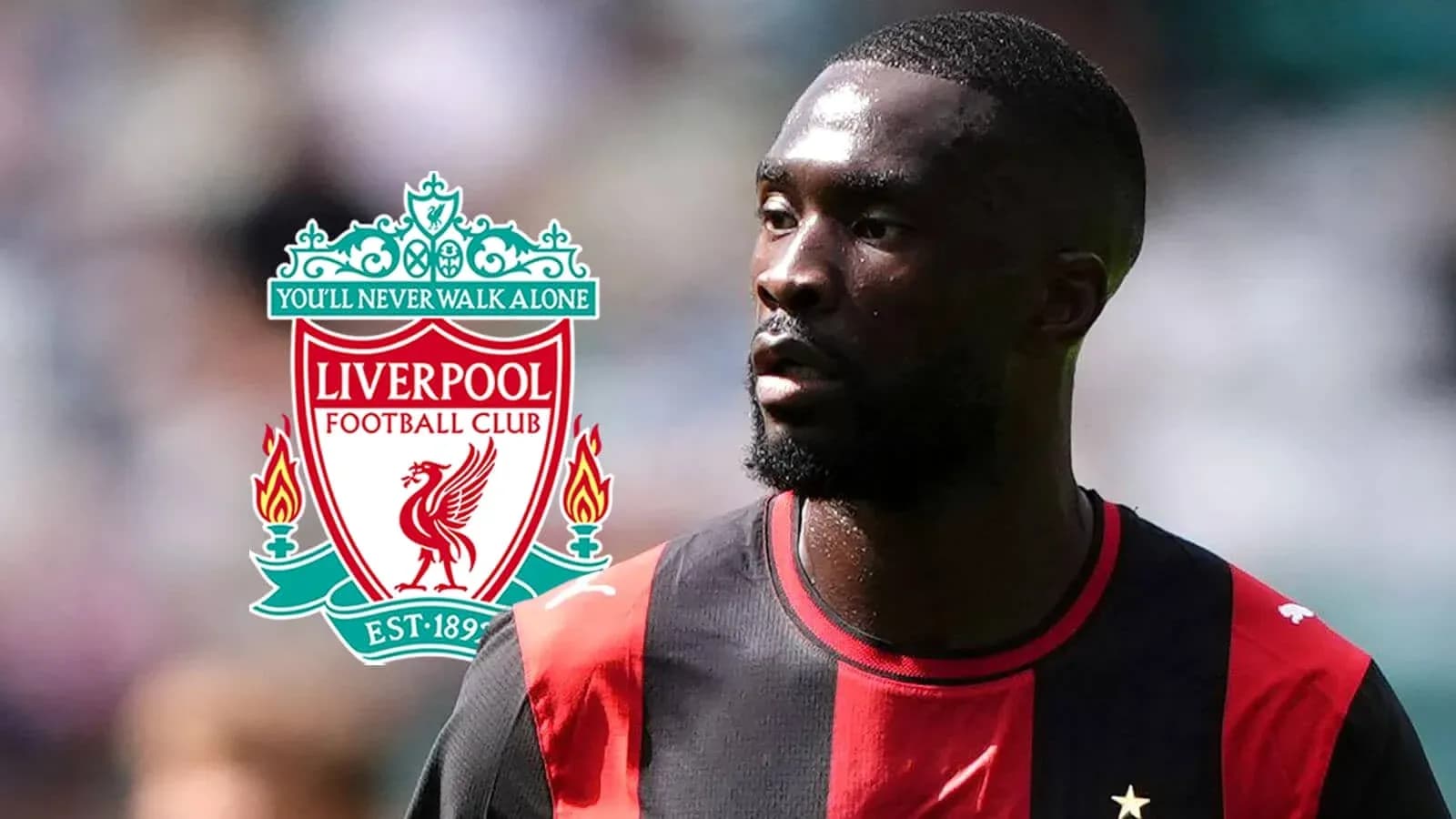 Jugador con camiseta negra y roja junto al logo de Liverpool Jugador con camiseta negra y roja junto al logo de Liverpool