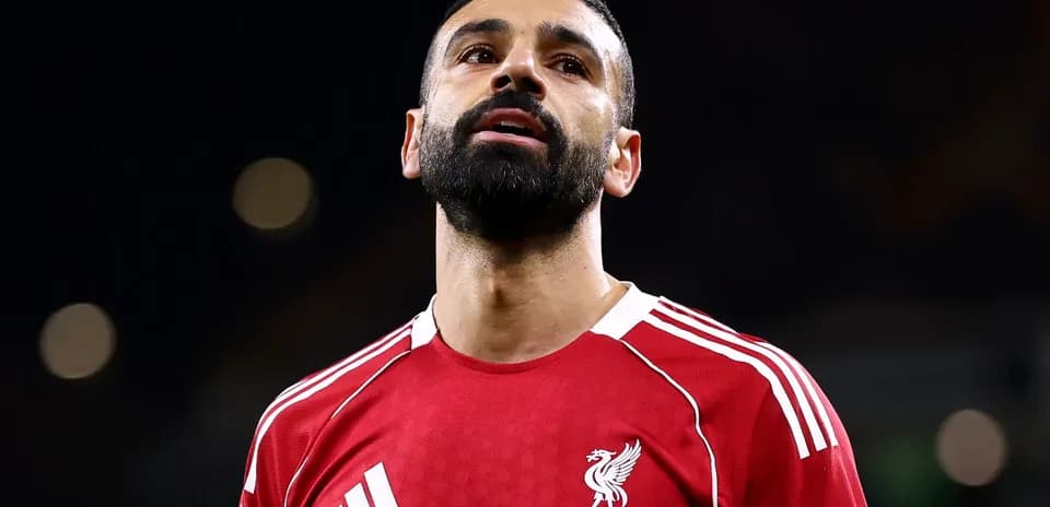 Jugador de Liverpool F.C. con camiseta roja mirando hacia arriba Jugador de Liverpool F.C. con camiseta roja mirando hacia arriba