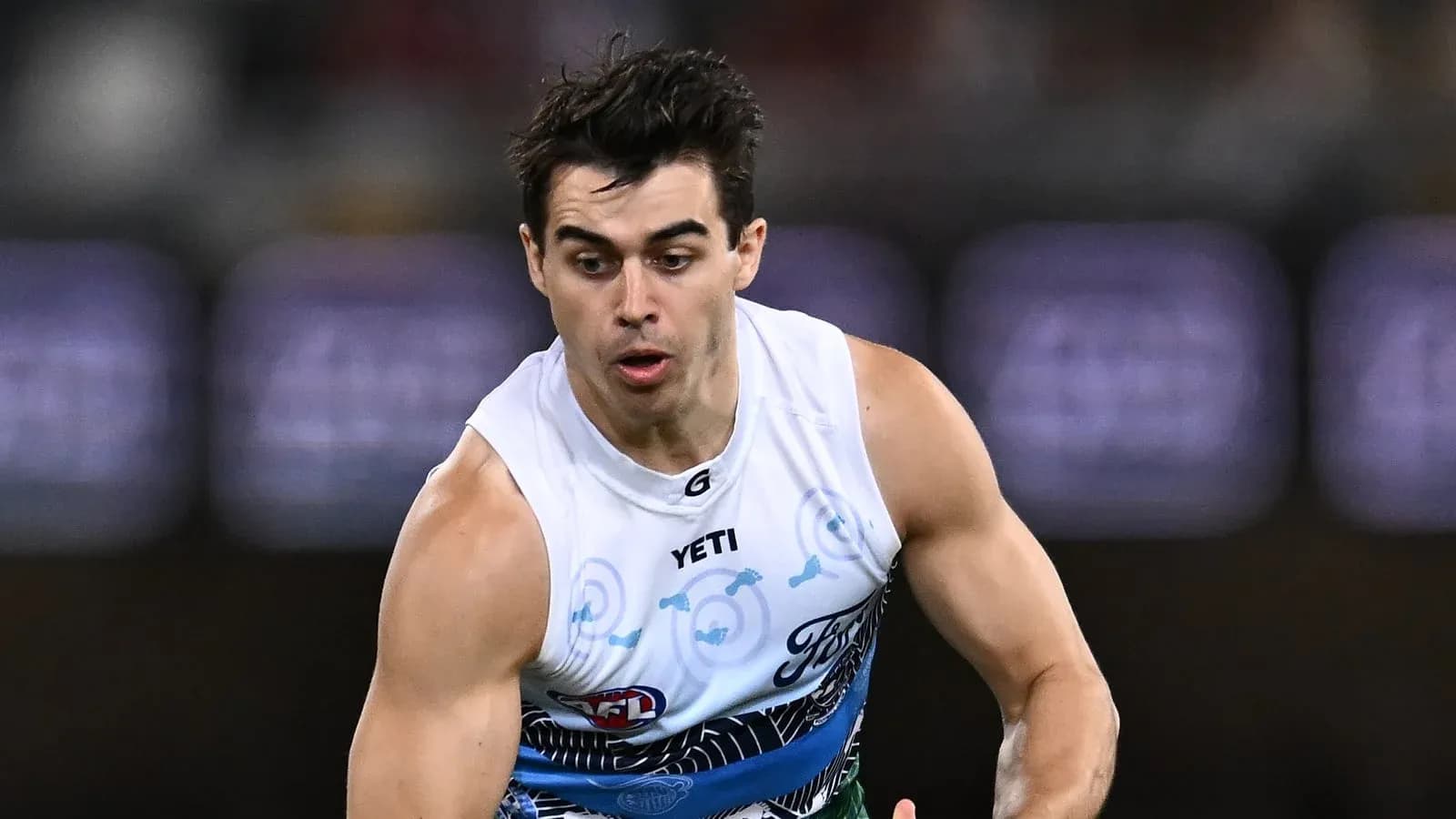 Jugador corriendo durante un partido de AFL Jugador corriendo durante un partido de AFL