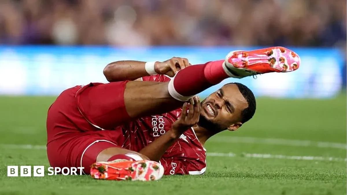 Jugador de Liverpool en el suelo con lesión Jugador de Liverpool en el suelo con lesión
