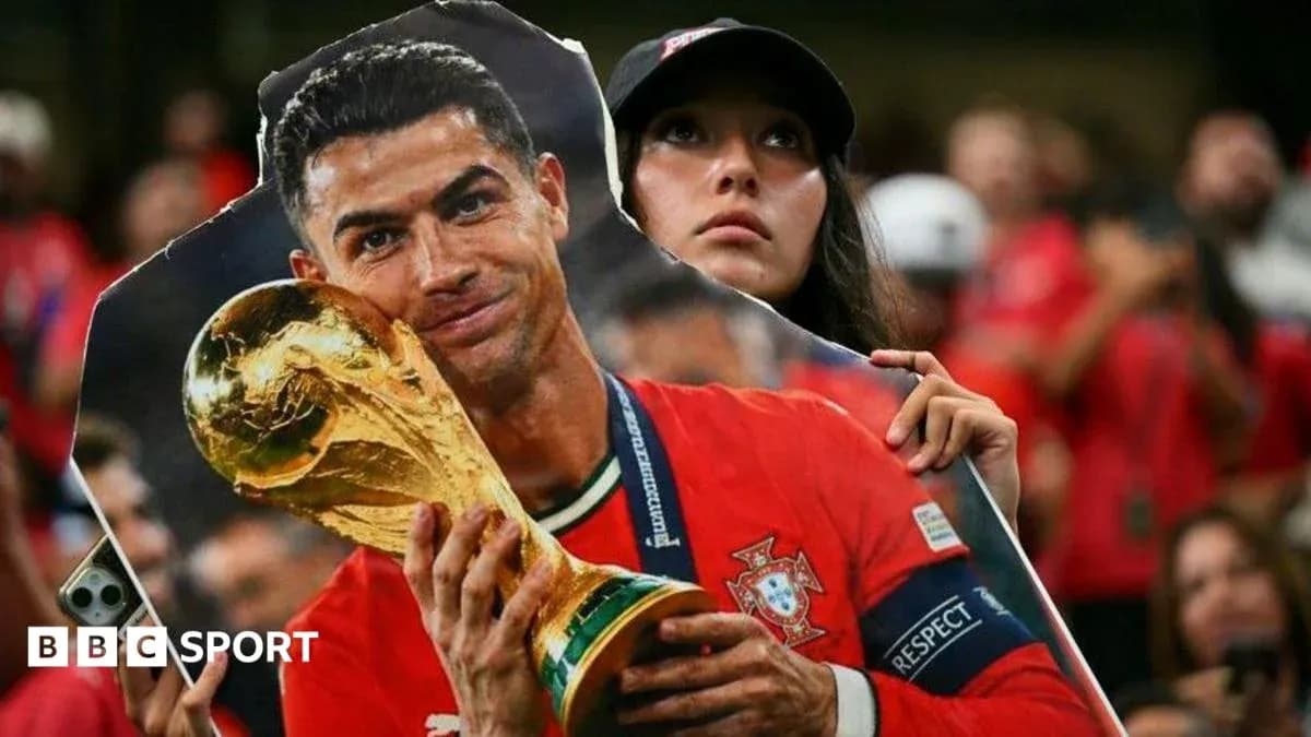 Fan holding a poster of Cristiano Ronaldo with trophy Fan holding a poster of Cristiano Ronaldo with trophy