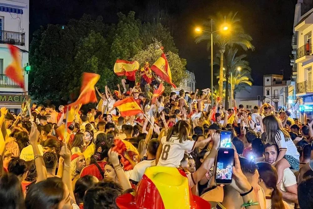 Celebration with fans waving Spanish flags at night Celebration with fans waving Spanish flags at night