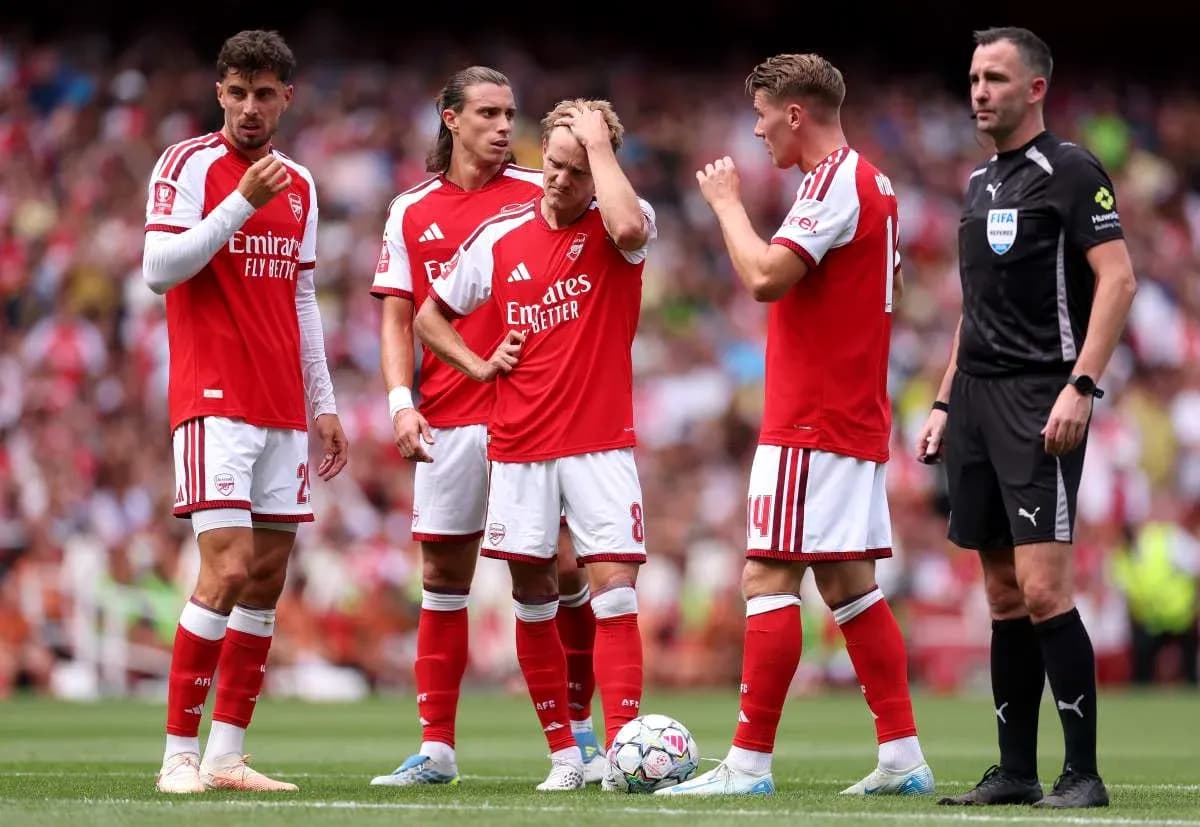 Jugadores de Arsenal discutiendo con el árbitro en el campo Jugadores de Arsenal discutiendo con el árbitro en el campo