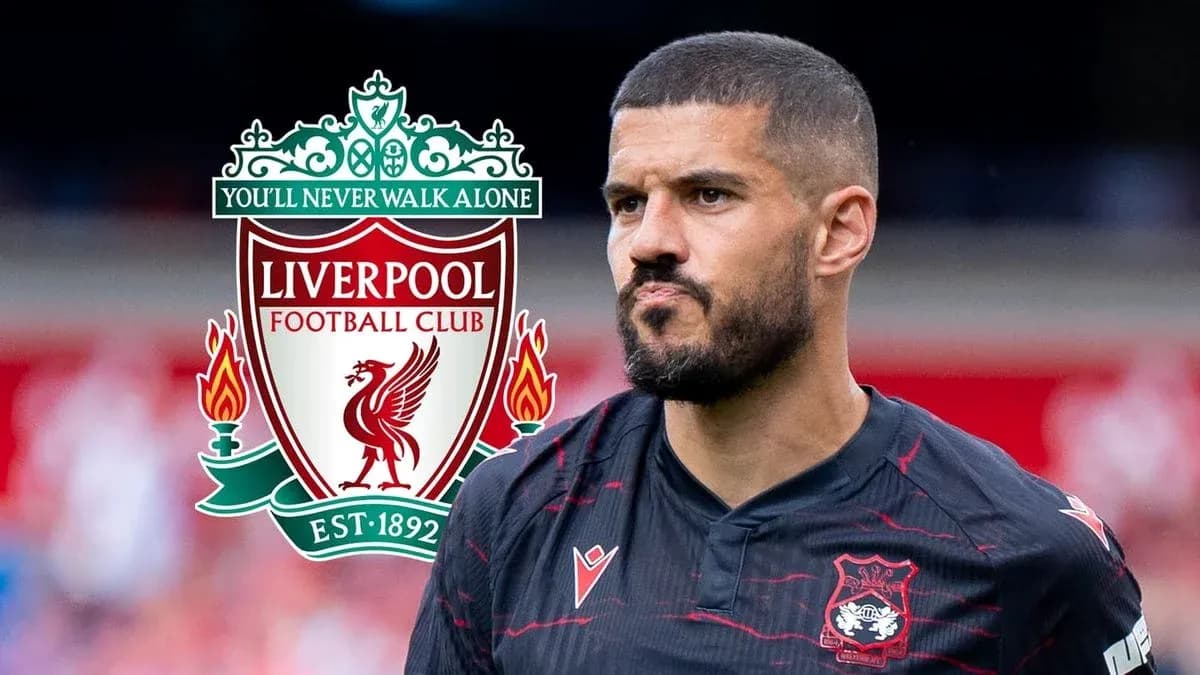 Jugador con camiseta negra frente al logo de Liverpool Jugador con camiseta negra frente al logo de Liverpool