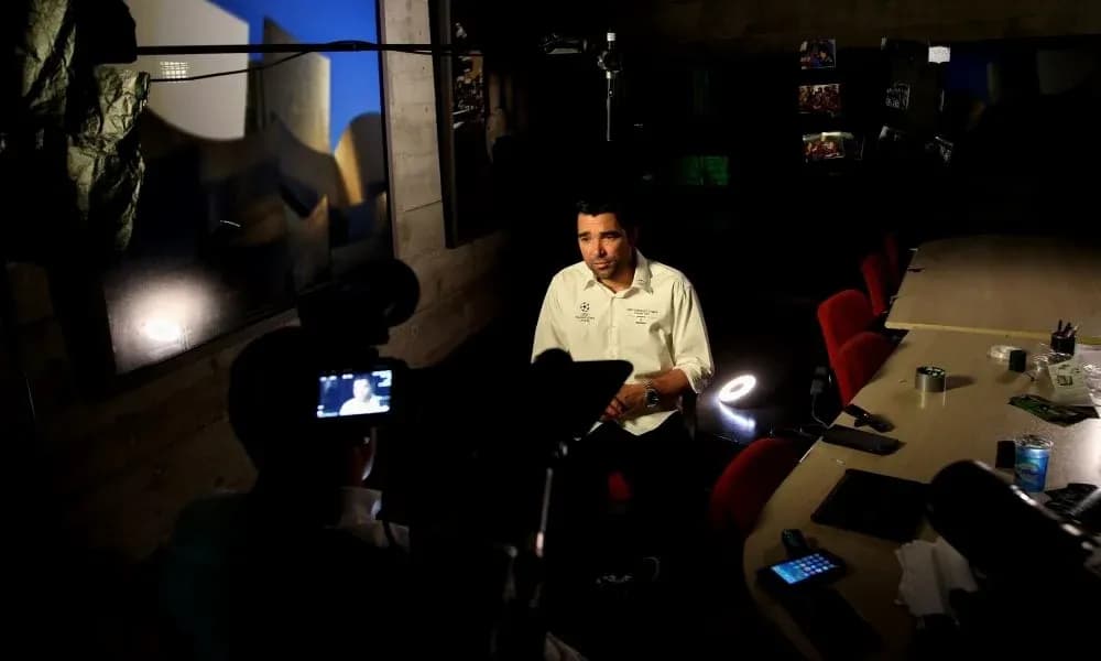 Entrevista en estudio con hombre sentado frente cámara Entrevista en estudio con hombre sentado frente cámara